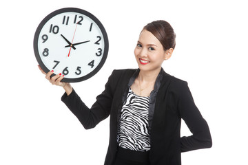 Young Asian business woman with a clock