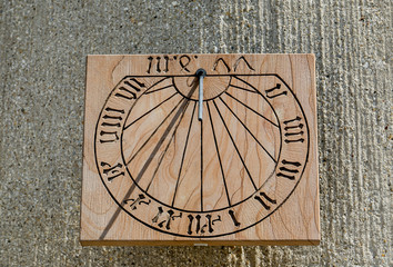 Antique wooden sundial showing time with shadow