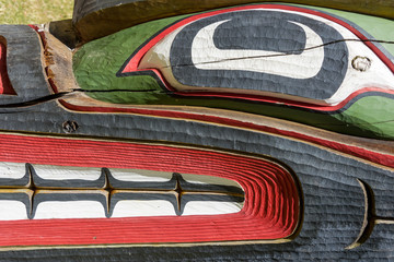 Close up detailing of an Native American carved ancient wooden colorful Totem pole in Victoria at...