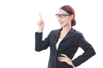 Portrait of young businesswoman wearing glasses pointing up on white background