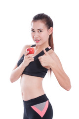 Fitness young woman holding apple and showing thumb up on white background. healty concept