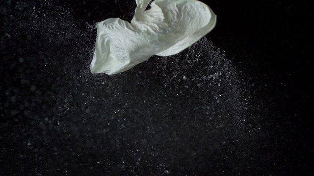 Popping water balloon on black background shooting with high speed camera, phantom flex.
