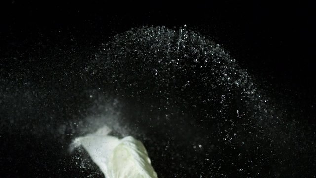 Popping water balloon on black background shooting with high speed camera, phantom flex.