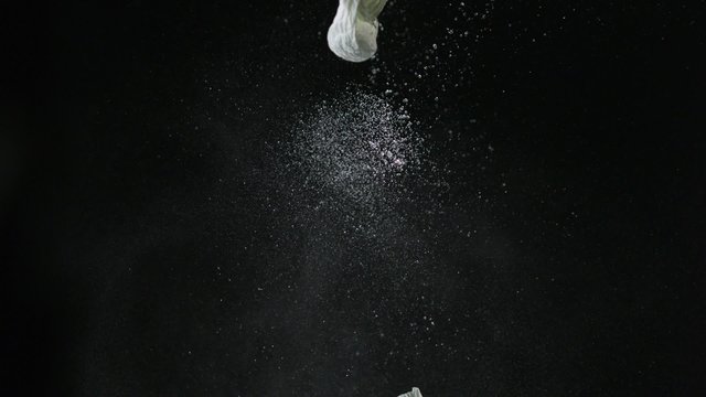 Popping water balloon on black background shooting with high speed camera, phantom flex.