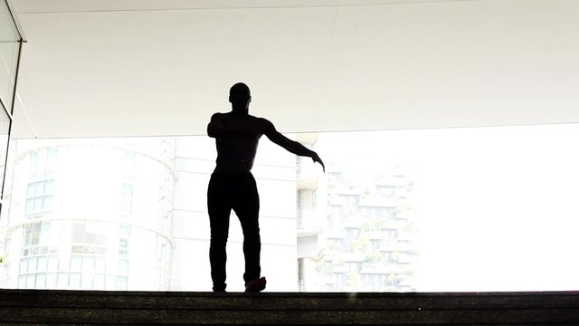 Dancer silhouette performing in the city
