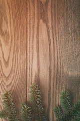 vertical background with fir branch over oak table