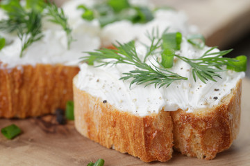 crunchy baguette slices with cream cheese and herbs