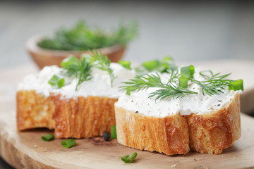 crunchy baguette slices with cream cheese and herbs