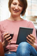 Woman At Home Reading E-Book Drinking Wine