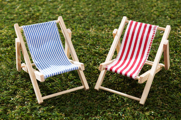 Two Model Deckchairs On Grass