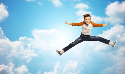 Fototapeta na wymiar happy smiling boy jumping in air