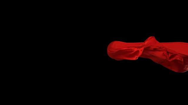 Red fabric flowing in the air on black background shooting with high speed camera, phantom flex.