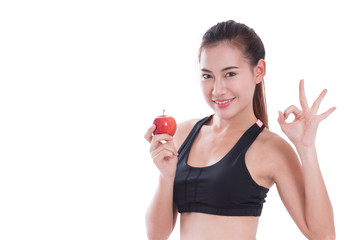 Fitness woman holding apple and showing ok sign