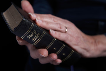 Close Up Of Senior Woman Holding Bible