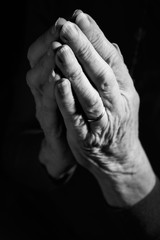 Black & White Image Of Senior Woman's Hands Joined In Prayer