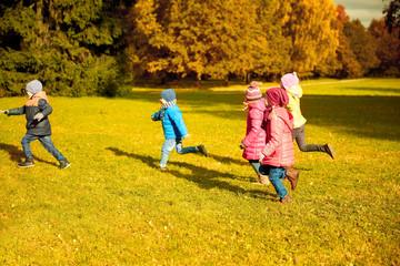 Fototapeta premium group of happy little kids running outdoors