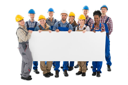 Happy Construction Workers Holding Blank Billboard - Powered by Adobe