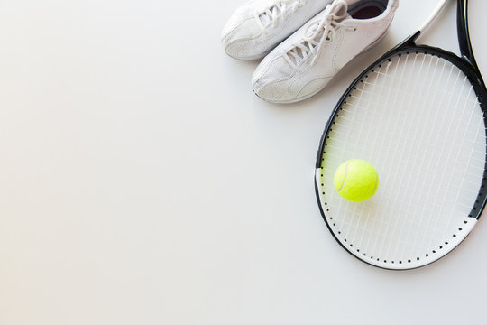 close up of tennis racket with ball and sneakers © Syda Productions