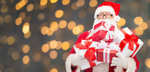 man in costume of santa claus with gift boxes