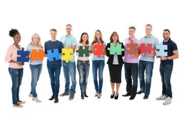 Fototapeta premium Creative Business People Holding Jigsaw Pieces