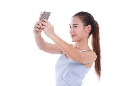 Happy young woman taking a selfie using her smartphone 