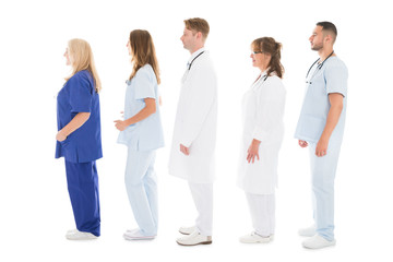 Side View Of Medical Professionals Standing In Row