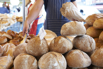 Man Serving On Bread Stall At Outdoor Market