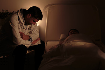 Fototapeta premium Doctor watching over his patient