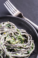 Black pasta with spinach, mascarpone and Parmesan