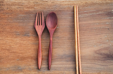 wooden spoon, fork and chopsticks on rustic wooden background