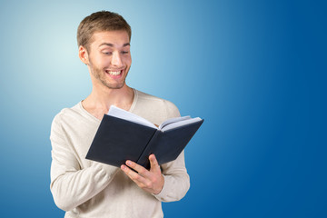 Handsome young business man reading a book