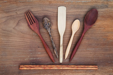 Wooden Spoon, fork, wooden butter knife, chopsticks on rustic wooden background
