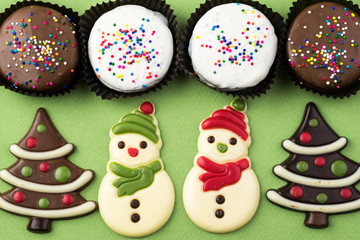 Assorted chocolate snowmen, candy trees and cookies.