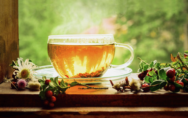 Glass cup with hot black tea
