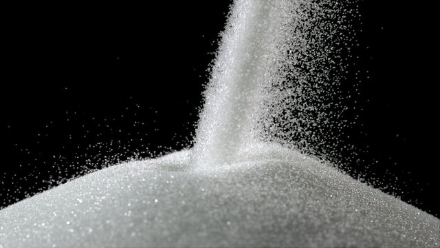 Pile of sugar on black background shooting with high speed camera, phantom flex.