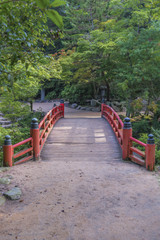 Traditional Japanese style bridge at the entrance to Momiji-dani