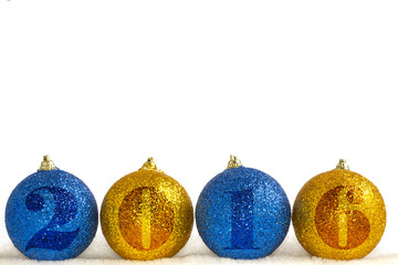 Christmas decorations on a white background. Four balls on artificial snow