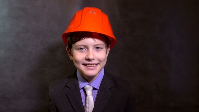 teen portrait boy builder in helmet smiling 