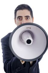 Man dressed in suit and tie shouting through megaphone.