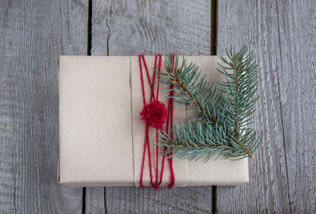 Christmas gift box handicraft wrapping, parchment, fir tree, twig. Top view.