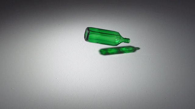 Dropping and smashing glass bottle shooting with high speed camera, phantom flex.