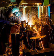 MIG welder uses torch to make sparks during manufacture of metal equipment.
