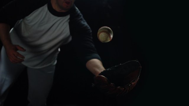 Baseball player diving to catch ball shooting with high speed camera, phantom flex.