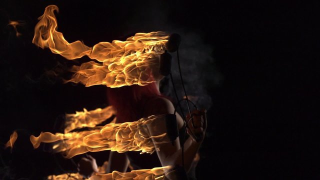 Fire performer playing with fire shooting with high speed camera, phantom flex.