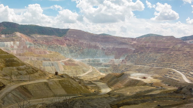Spectacular panoramic time-lapse of mining trucks in open cast quarry surface copper mine, New Mexico, USA