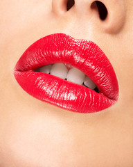 Fototapeta premium Woman's lips with red lipstick.