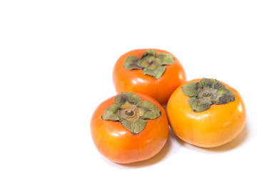 Fresh ripe persimmons on white background