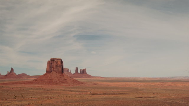 Time-lapse panorama of Monument Valley, Arizona Utah USA.
Sped up clouds above red rock desert floor, classic American vista