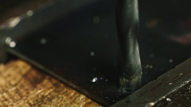 The drill drills metal part