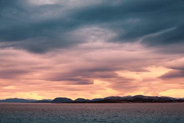 Fototapeta na wymiar Norwegian coastal landscape, colorful stormy sky
